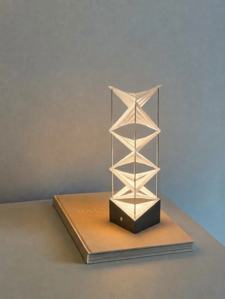 Float lit on a closed book against a grey wall